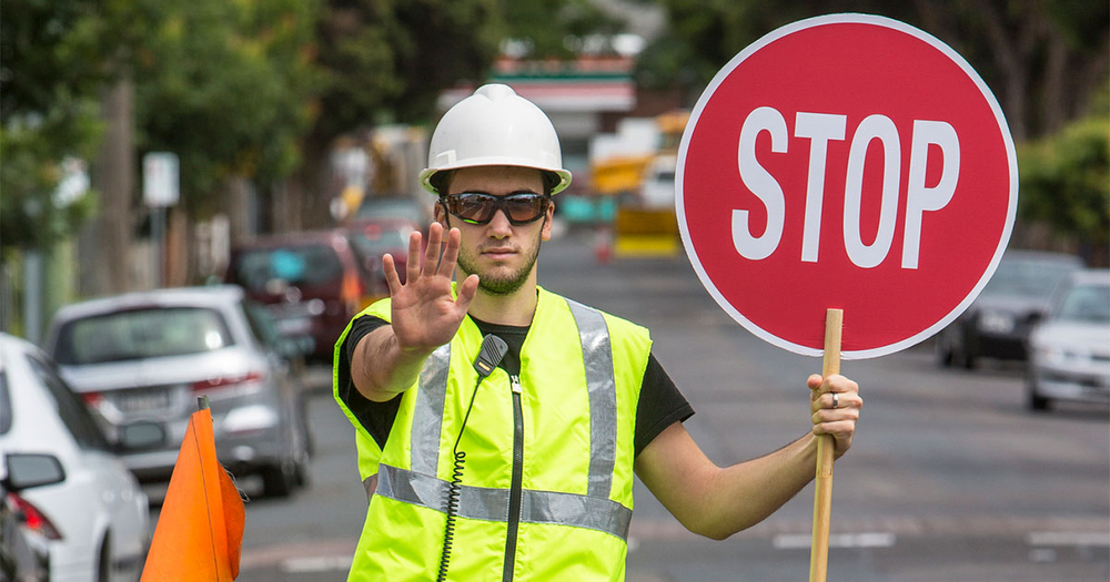 Traffic controller holding a stop sign