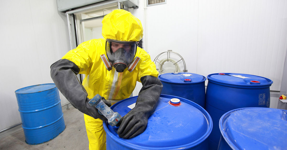 Man wearing ppe mask while handling chemicals