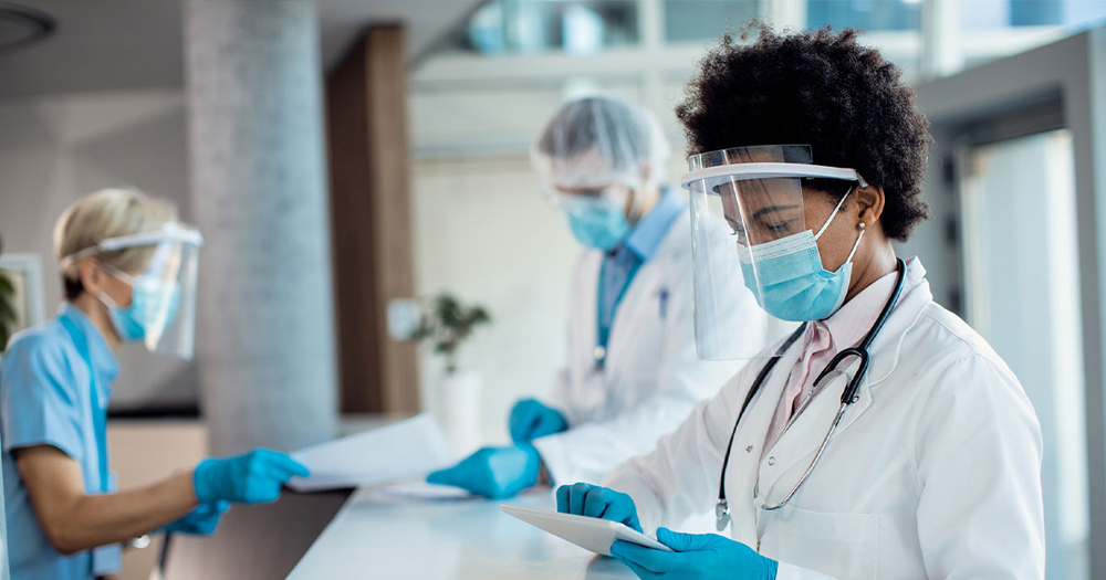 Doctor wearing ppe in doctors office