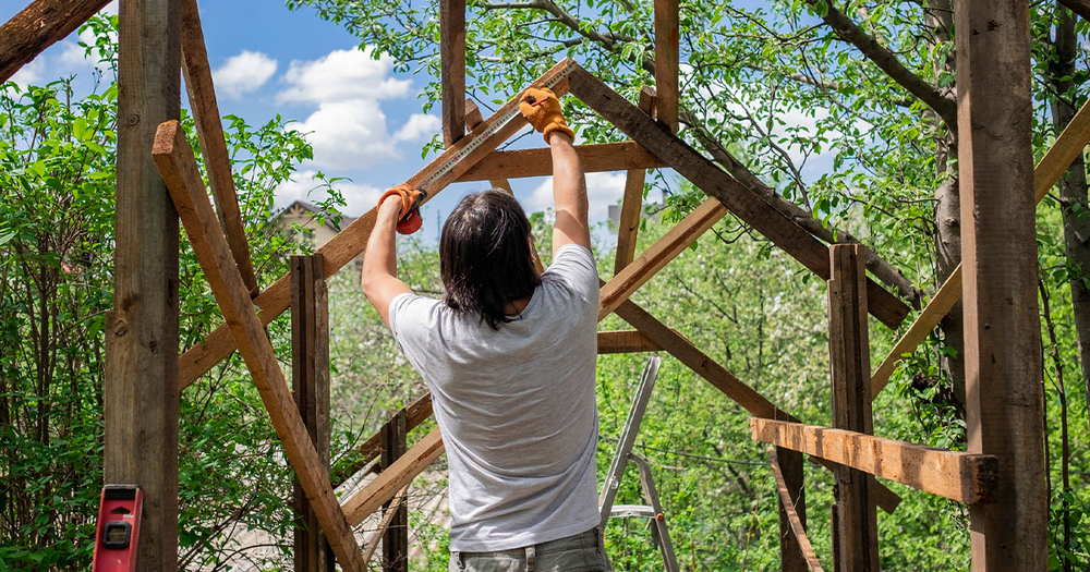 Man-building-house-on-empty-property