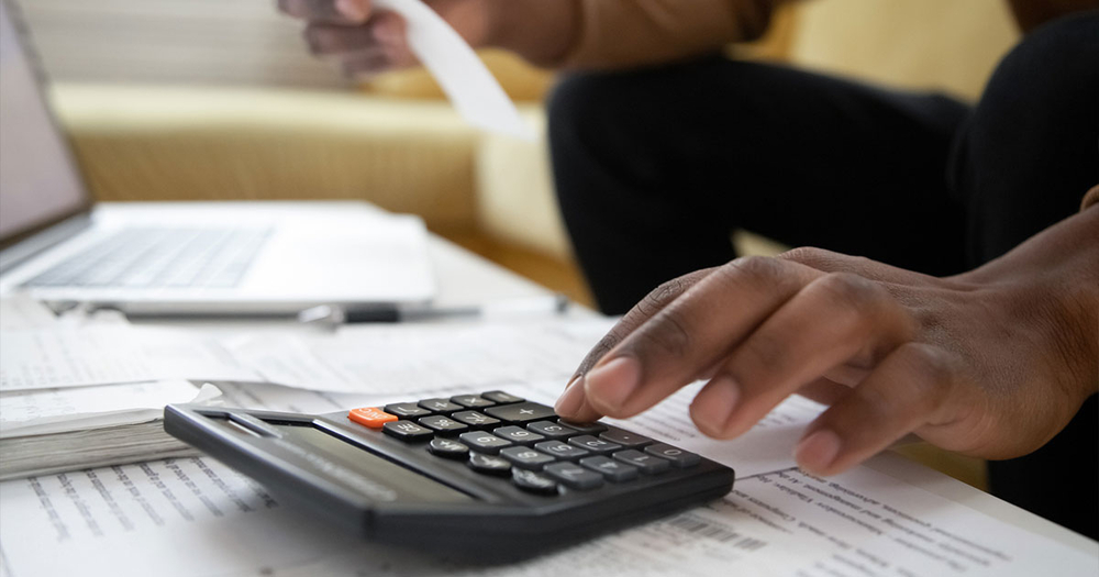 man-with-calculator-doing-taxes