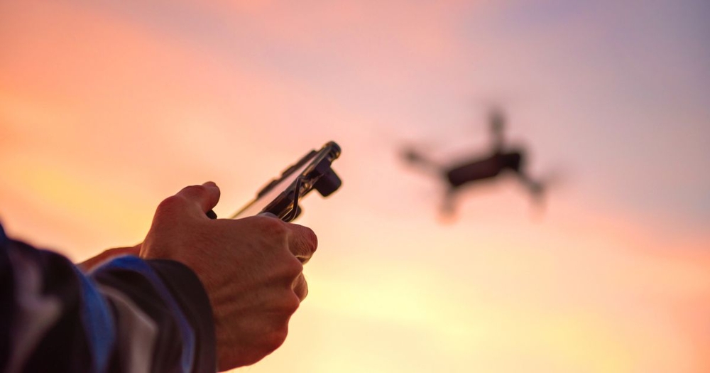 Closeup of hands flying drone