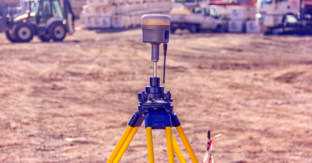 A GPS land survey tool being used at a construction site.