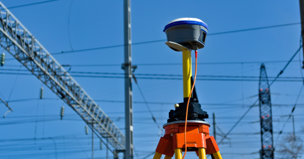 A GNSS base receiver being used at a train station for a land survey project.