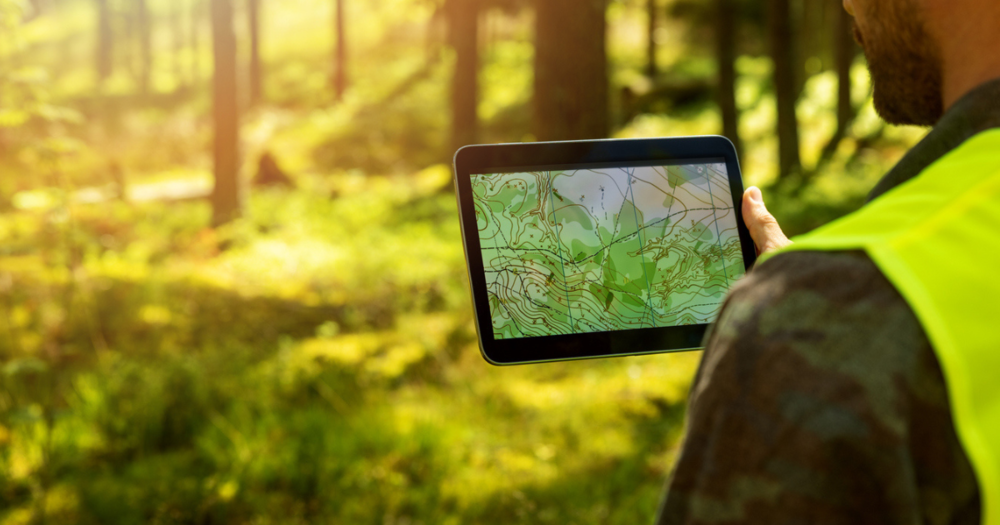 A land surveyor looking at a topographical map made from a GPS land survey.