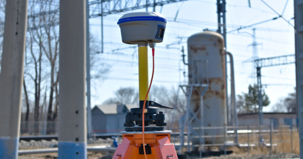 A GPS land survey equipment next to a railroad.