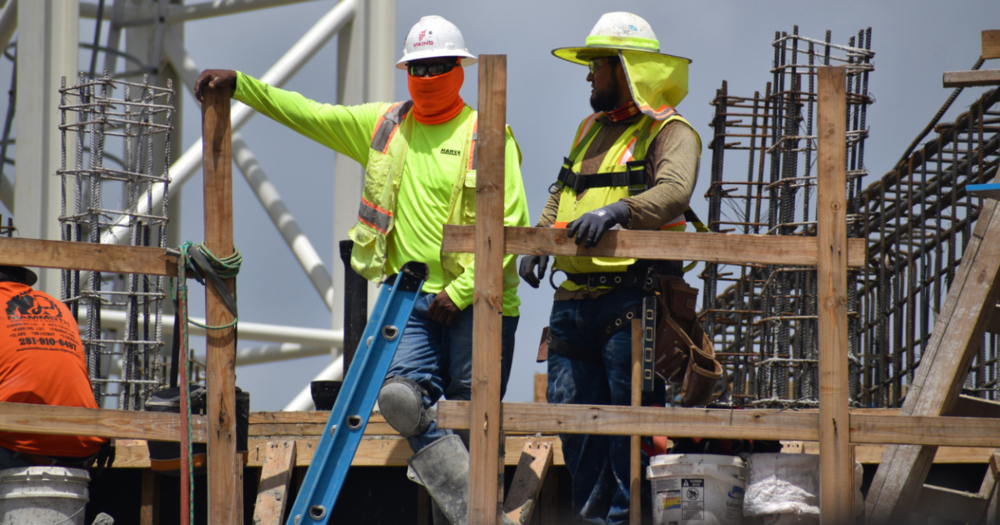 Construction workers in their heat stress protection gear.